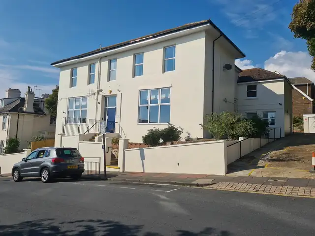 Cream painted rendered house exterior in Brighton